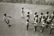 Officer instructing lines of woman, Guinea