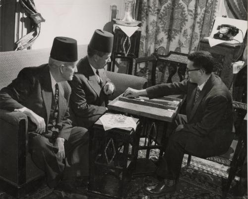 Men in fezzes playing board game, Syria