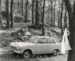 Ford Cortina introduction booklet: woman sitting on hill by car, Scotland