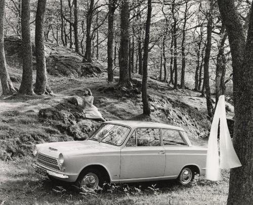 Ford Cortina introduction booklet: woman sitting on hill by car, Scotland