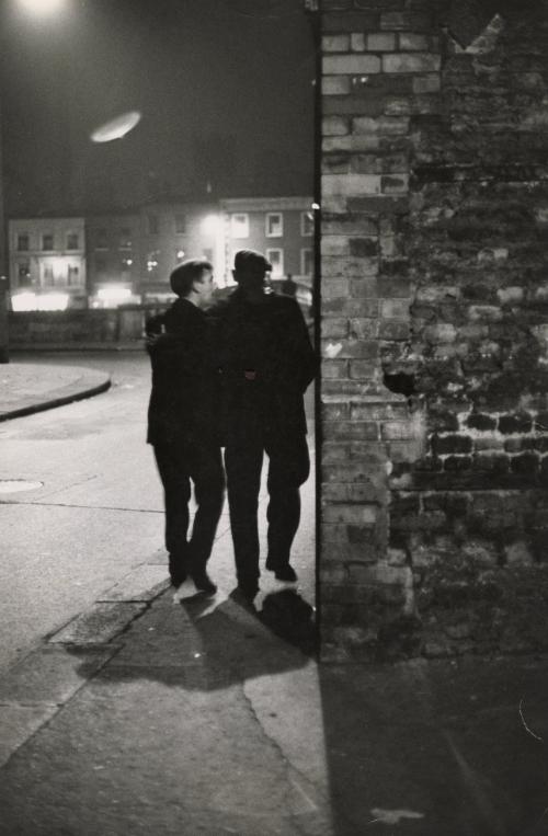 Street scene with two men walking together at night, Dublin