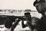 Minister of Defense Moshe Dayan looking through telescope while visiting the Suez Canal with General Dan Laner