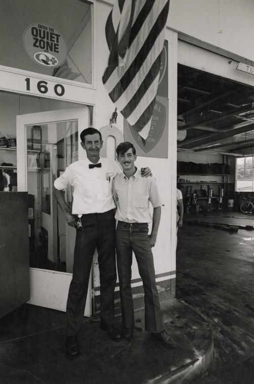 Father and son working at gas station, Tri-Valley Area, Northern California