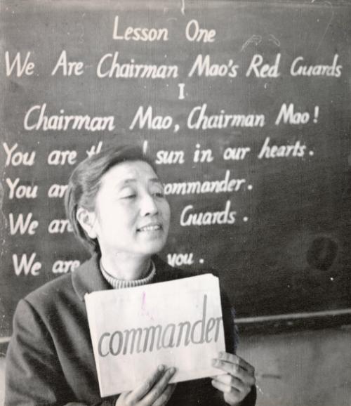 A Child's First Lesson: teacher in a Peking school holds up card for children to repeat in English language class. Poems on Chairman Mao and the Red Guard movement are subjects in first year class of 23rd secondary school of Peking