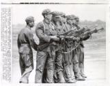 Ready On the Firing Line: a Chinese Army squad prepares to fire in a small arms demonstration at the 196th Division of the Greater Peking Municipality. The vice commander of the division says its main task is to be militarily prepared to defend China and liberate Taiwan