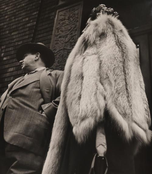 Man in suit, woman in fur coat
