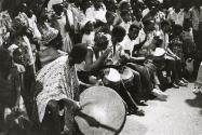 Drummers performing with crowd behind them, Guinea