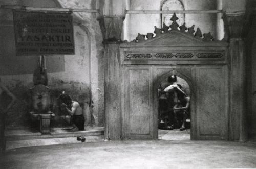 Two men through archway at Cağaloğlu Hamam, Istanbul, Turkey