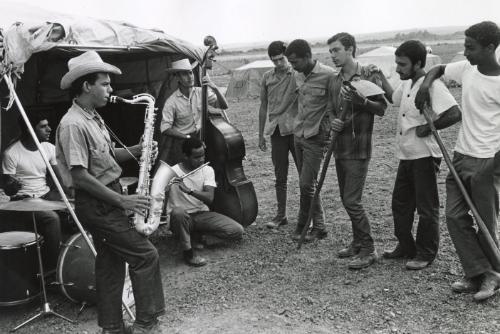 Students at the countryside (men playing instruments outdoors)