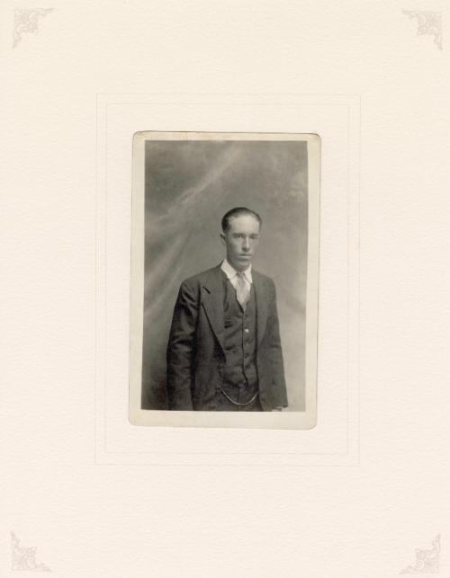 Well-dressed man in three-piece suit, cloud background