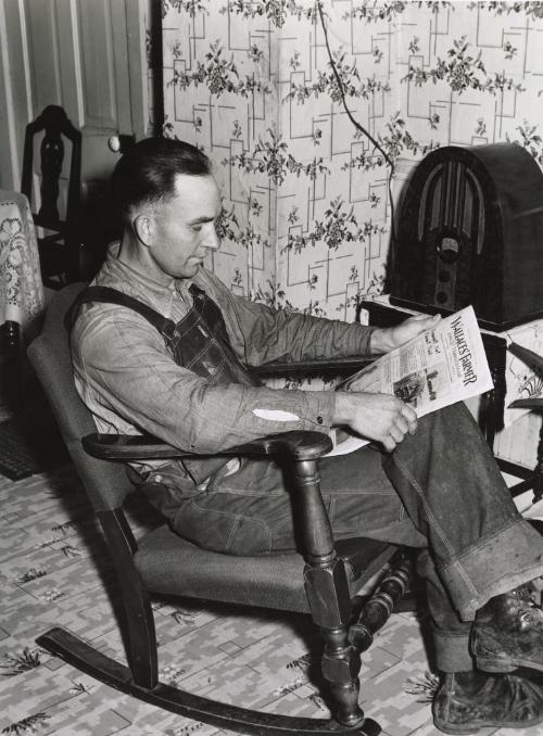 Farmer reading newspaper