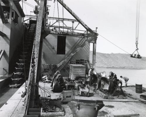 This is the only gold dredge in the continental United States.  It operates around the clock, seven days a week, moving three million cubic yards of sand and gravel every year.  The dredge makes twenty-five cents per cubic yard and with the depressed gold market somtimes doesn't break even. Tri-Valley Area, Northern California, from the series "Working"