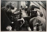 Man with a woman and a radio in his lap, New York, from the "Hipshot" series.