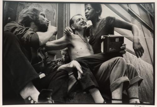 Man with a woman and a radio in his lap, New York, from the "Hipshot" series.
