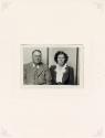 Untitled [Seated serious couple, striped background]