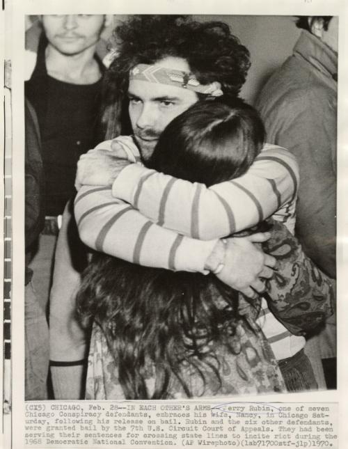 In Each Other's Arms: Jerry Rubin, one of seven Chicago Conspiracy defendants, embraces his wife, Nancy, in Chicago Saturday, following his release on bail. Rubin and the six other defendants were granted bail by the 7th U.S. Circuit Court of Appeals. They had been serving their sentences for crossing state lines to incite riot during the 1968 Democratic National Convention.