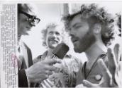 Yippie Leader: Jerry Rubin (right), wearing a RE-ELECT NIXON button, expresses himself to a TV newsman about the upcoming Democratic convention on the lawn of Conventional Hall. With Rubin was Stew Albert. Both are leaders of the Youth International Party. They said they were sent to Miami Beach by the Yippies to survey the convention site. Rubin predicted that 10,000 nudes would march down Washington Avenue in front of convention hall when the Democrats convene in July.