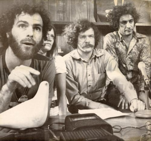 Promise Peace: Yippie Jerry Rubin, left, and his lieutenants announce plans for nonviolent activities during the July 10-14th Democratic National Convention. Other Youth International Party leaders in Miami Beach Tuesday were, from left: Patty Oldenburg, partly hidden  Ed Sanders  and Abbie Hoffman. Rubin points to a bird of peace sculpture.