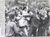 Coming to Blows: Demonstrators attack Chicago police commander Paul McLaughlin, left, and an undidentified sergeant during clash outside Chicago's Federal Building yesterday where eight persons are on trial for conspiring to promote riots during the 1968 Democratic National Convention.