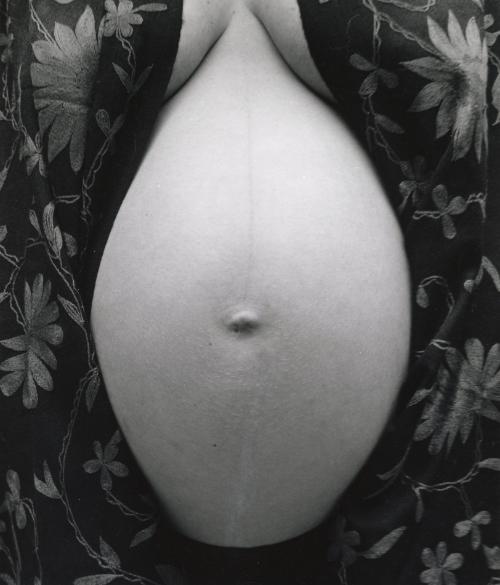 Pregnant nude stomach with flowered robe