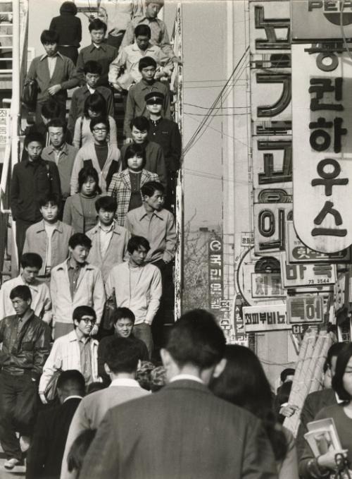 Crowd descends stairs in city center, Japan, 1960