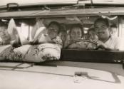 Portrait of large family in car, South America, ca. 1960s