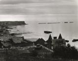 Coastal landscape with World War II tank in yard, England, c. 1960