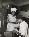 A mother and student in conference with her university professor, Ivory Coast or Nigeria, c. 1960