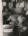 Mother bathing her infant, Latin America, 1950s