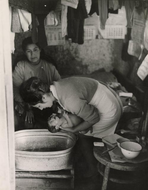Mother bathing her infant, Latin America, 1950s