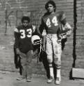 Jose Eskelin (The Policeman) or Football Players, Buffalo, NY, 1972 / 1985 / 1992 / 2002