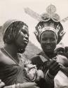 Zulu women show their jewelry to European visitors, South Africa, 1953