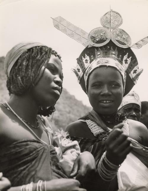 Zulu women show their jewelry to European visitors, South Africa, 1953