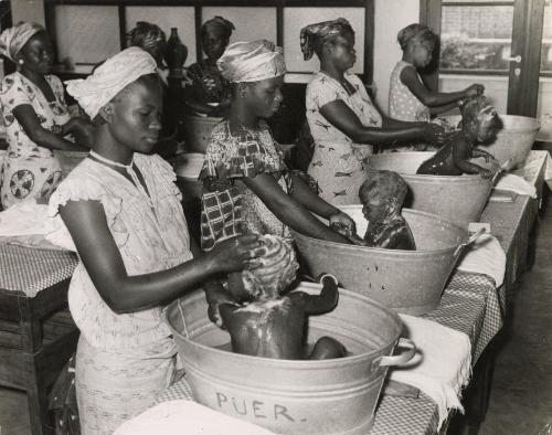 Mothers bathing their babies at a baby care course at the Red Cross, Leopoldville, the Belgian Congo (now Kinshasa, Democratic Republic of the Congo), 1957